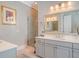 Bright bathroom with gray cabinets, double vanity, glass shower and marble countertops at 1141 Hills Plantation Dr, Charleston, SC 29412
