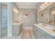 Elegant bathroom featuring dual vanities with stone countertops, stylish mirrors, and neutral tones for a spa-like ambiance at 1141 Hills Plantation Dr, Charleston, SC 29412