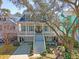 Inviting two-story home with a charming front porch, manicured landscaping, and beautiful curb appeal at 1141 Hills Plantation Dr, Charleston, SC 29412