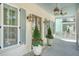 Lovely front porch with potted plants, outdoor lighting and ceiling fan at 1141 Hills Plantation Dr, Charleston, SC 29412