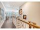 Elegant hallway with hardwood floors, staircase, and decorative artwork at 1141 Hills Plantation Dr, Charleston, SC 29412