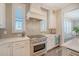 Close up view of kitchen featuring a cooktop, oven, vent hood and wine fridge at 1141 Hills Plantation Dr, Charleston, SC 29412