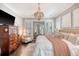 Sophisticated main bedroom with a plush bed, elegant chandelier, and classic decor, creating a relaxing retreat at 1141 Hills Plantation Dr, Charleston, SC 29412
