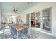Screened in porch with wood table, seating for six, and ceiling fan overlooking views of the water at 1141 Hills Plantation Dr, Charleston, SC 29412