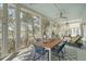 Enclosed porch with outdoor seating, wood table, ceiling fan, and views of the lake and surrounding trees at 1141 Hills Plantation Dr, Charleston, SC 29412