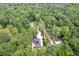 Aerial view of the property, highlighting the house, driveway, and surrounding trees at 128 Paul Dr, Summerville, SC 29483