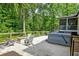 Backyard features a hot tub and firepit surrounded by Adirondack chairs and lush landscaping at 128 Paul Dr, Summerville, SC 29483