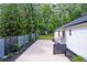 Backyard featuring a new fence and gravel driveway with fresh landscaping and a small shed at 128 Paul Dr, Summerville, SC 29483