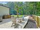 A backyard with a firepit and Adirondack chairs is surrounded by mulch and trees, providing a tranquil setting at 128 Paul Dr, Summerville, SC 29483