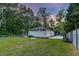 Landscaped backyard with lush green lawn and mature trees at 128 Paul Dr, Summerville, SC 29483
