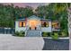 Charming exterior of a well-maintained home featuring a manicured lawn, gravel driveway and inviting front porch at 128 Paul Dr, Summerville, SC 29483