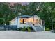 Charming home featuring a well-manicured lawn, a front porch with an American flag, and mature trees at 128 Paul Dr, Summerville, SC 29483