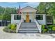 Charming home featuring a welcoming front porch and black-and-white stairs at 128 Paul Dr, Summerville, SC 29483