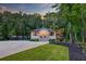Beautiful home with a well-manicured lawn, featuring a covered porch and mature trees at 128 Paul Dr, Summerville, SC 29483