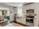 Well-lit kitchen with stainless steel appliances, granite countertops, and white cabinets at 128 Paul Dr, Summerville, SC 29483