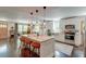 Open-concept kitchen featuring an island with seating, pendant lights, and stainless steel appliances at 128 Paul Dr, Summerville, SC 29483