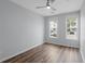 Empty bedroom showcasing hardwood floors and two windows with views of the exterior building at 130 River Landing Dr # 4102, Charleston, SC 29492