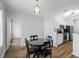 Cozy dining area featuring a black table and chairs, with views of the kitchen and entrance at 130 River Landing Dr # 4102, Charleston, SC 29492