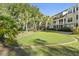 A community green space features putting green, mature trees, and community seating at 130 River Landing Dr # 4102, Charleston, SC 29492