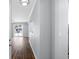 Hallway view showcasing wood floors, leading to a bright living area with a sliding door to the outside at 130 River Landing Dr # 4102, Charleston, SC 29492