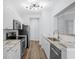 Well-lit kitchen featuring stainless steel appliances, sleek white cabinets, and a subway tile backsplash at 130 River Landing Dr # 4102, Charleston, SC 29492