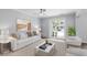 Bright living room with neutral tones, stylish furnishings, and sliding glass doors to outdoor area at 130 River Landing Dr # 4102, Charleston, SC 29492
