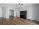 Spacious living room featuring hardwood floors, a modern TV, and decorative double doors at 130 River Landing Dr # 4102, Charleston, SC 29492