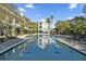 A lovely swimming pool reflects the surrounding property and clear blue sky above at 130 River Landing Dr # 4102, Charleston, SC 29492