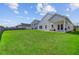 Large backyard with green grass and a home featuring a covered patio at 134 Percheron Dr, Summerville, SC 29486