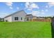 Wide shot of the large backyard and the home featuring a covered patio at 134 Percheron Dr, Summerville, SC 29486