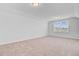 Spacious carpeted bedroom with a bright window bringing in natural light at 134 Percheron Dr, Summerville, SC 29486