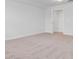 Large carpeted bedroom with walk-in closet and neutral colored walls at 134 Percheron Dr, Summerville, SC 29486