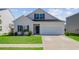 Charming two-story home with a well-maintained lawn, a garage, and a classic architectural style at 134 Percheron Dr, Summerville, SC 29486