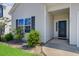 The front entrance has a black door with plants on each side and the house number above the door at 134 Percheron Dr, Summerville, SC 29486