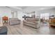 Bright open-concept living room showcases neutral walls, wood floors, and access to a modern kitchen at 134 Percheron Dr, Summerville, SC 29486