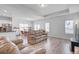 Open-concept living area with a leather sofa, lots of light, and views into the dining area at 134 Percheron Dr, Summerville, SC 29486
