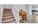 Carpeted staircase leading to the upper floors near wooden writing desk at 134 Percheron Dr, Summerville, SC 29486