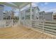 Exterior view from the wooden porch, showcasing the light blue siding and multiple balconies of the house at 1340 Lucinda St, Mount Pleasant, SC 29466