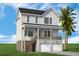 Inviting two-story coastal home boasts a charming design, double garage, and a relaxing front porch, complemented by a palm tree at 1340 Lucinda St, Mount Pleasant, SC 29466