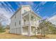 Elevated view of the home's exterior showcasing siding, porch with ceiling fan, and brick foundation at 1340 Lucinda St, Mount Pleasant, SC 29466