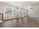 Spacious living room featuring gray wood flooring, coffered ceiling, and multiple windows offering ample natural light at 1340 Lucinda St, Mount Pleasant, SC 29466