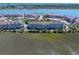 Aerial view of waterfront condos and a marina, offering stunning views and convenient access to boating at 142 Marsh View Villas, Folly Beach, SC 29439