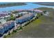 Aerial view of condo community on waterfront with tennis courts, fountains, and easy beach access at 142 Marsh View Villas, Folly Beach, SC 29439