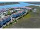 Aerial view of condo community on waterfront with tennis courts, fountains, and easy beach access at 142 Marsh View Villas, Folly Beach, SC 29439