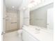 White bathroom features a shower, toilet, and vanity with large mirror at 142 Marsh View Villas, Folly Beach, SC 29439