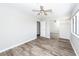 A neutral bedroom features wood-look floors, ceiling fan, and mirrored closet doors at 142 Marsh View Villas, Folly Beach, SC 29439