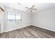 This bedroom features wood-look flooring, ceiling fan, and window with outdoor view at 142 Marsh View Villas, Folly Beach, SC 29439