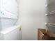A white stackable washer and dryer sit in a closet with white wire shelving and a cardboard box at 142 Marsh View Villas, Folly Beach, SC 29439