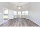 Corner living room with a fan and many windows at 142 Marsh View Villas, Folly Beach, SC 29439