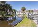 Waterway view features tropical landscaping and community buildings beyond at 142 Marsh View Villas, Folly Beach, SC 29439